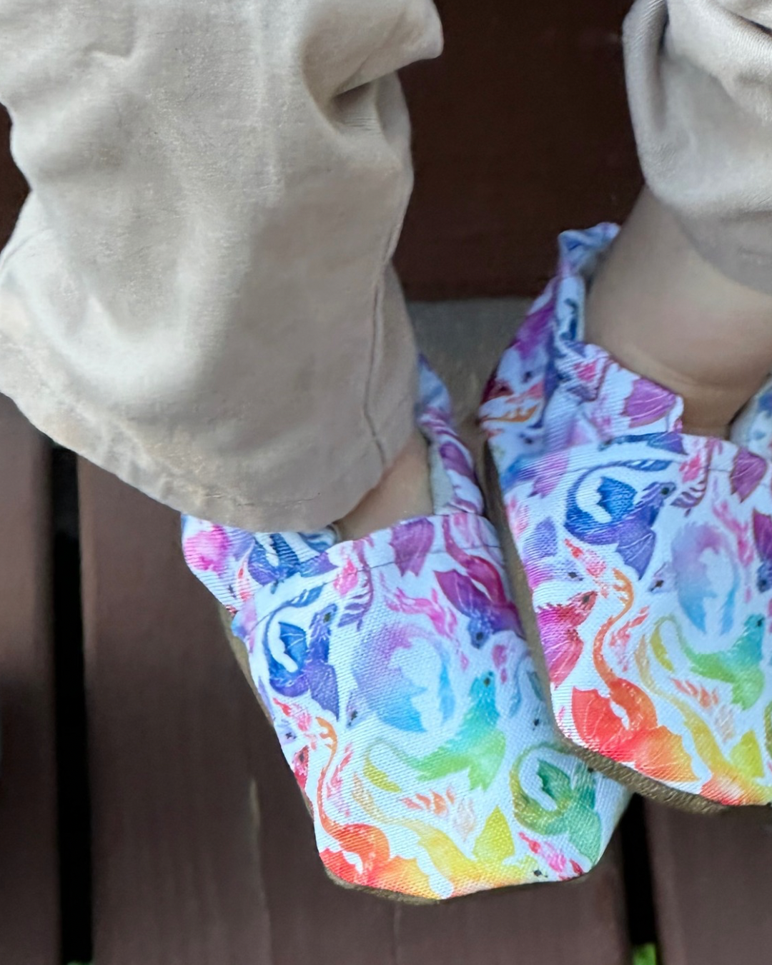 Lifestyle photo: Limited edition Rainbow Dragons eco-canvas Cabooties baby shoes