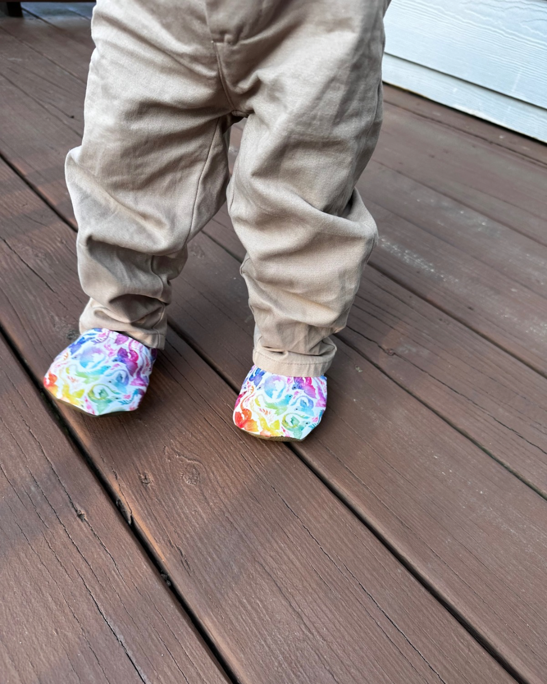 Lifestyle photo: Limited edition Rainbow Dragons eco-canvas Cabooties baby shoes