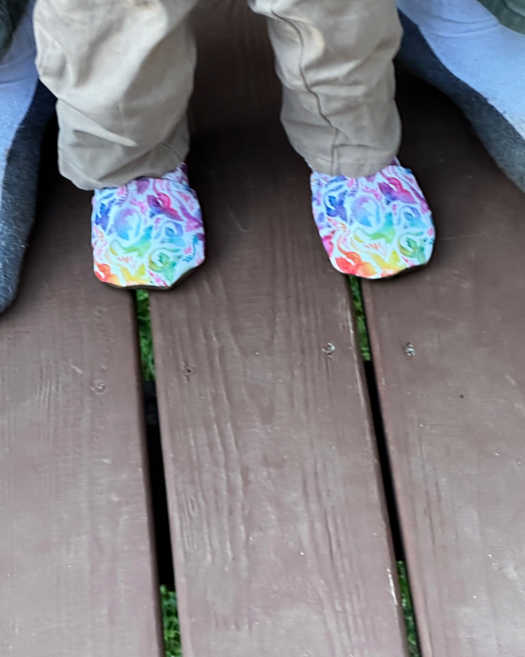 Lifestyle photo: Limited edition Rainbow Dragons eco-canvas Cabooties baby shoes