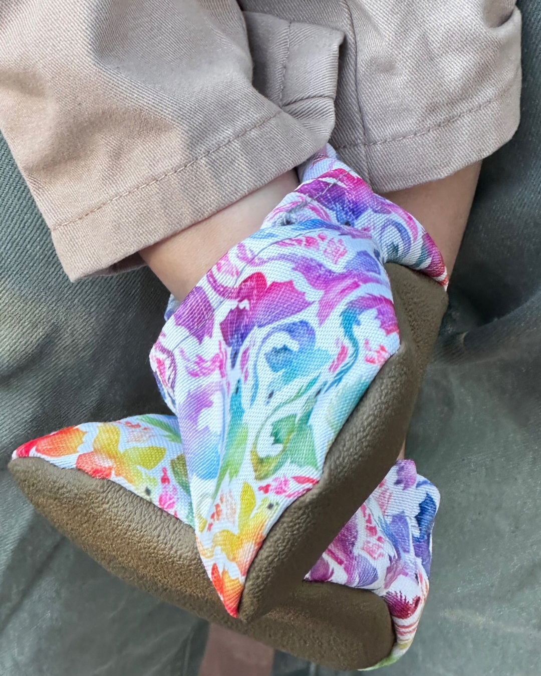 Lifestyle photo: Limited edition Rainbow Dragons eco-canvas Cabooties baby shoes