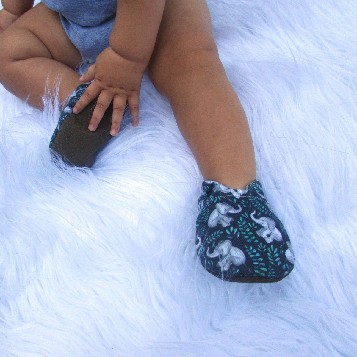 Child wearing Unforgettable Elephants limited edition eco canvas baby shoes by Cabooties